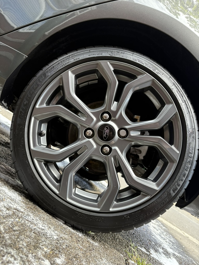 Clean grey Ford alloy wheel after detailing