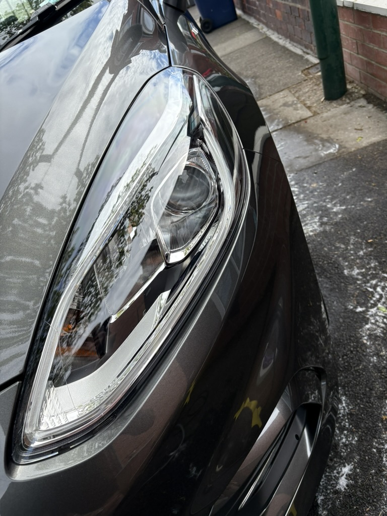 Clean brown car headlight close-up after detailing
